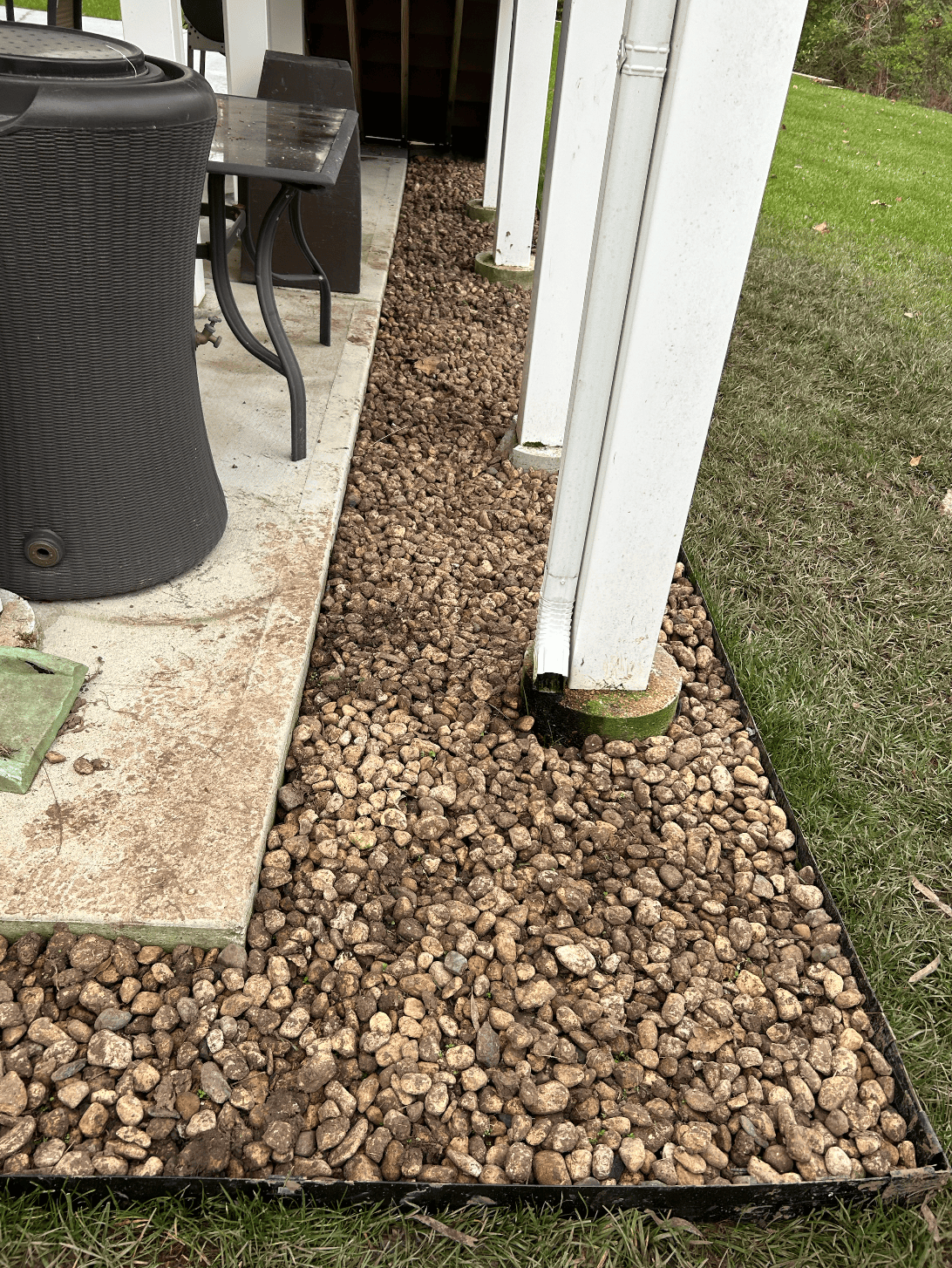 Decorative brown rock installed tightly along covered patio posts